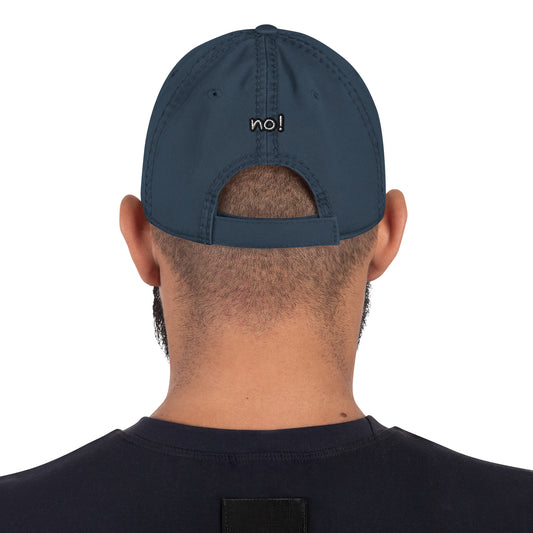 Rear view of a person wearing a navy Distressed Dad Hat – No Is a Complete Sentence with "no!" embroidered above the adjustable strap, showcasing casual, purpose-driven apparel.