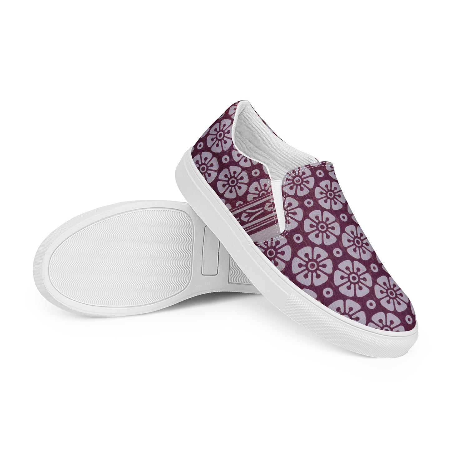 Pair of slip-on canvas shoes featuring a floral pattern in cranberry hues, embodying the Women's High Top Sneakers – Floral in Cranberry, with purpose-driven messaging and faith-inspired design.