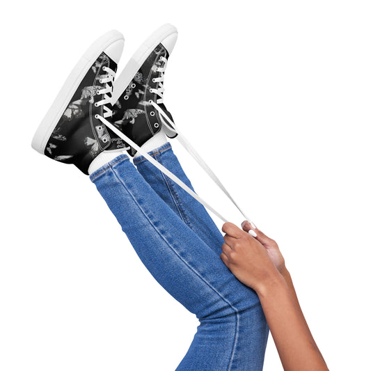 Pair of black high top canvas Women's High Top Sneakers – Butterfly with white soles and butterfly print, styled with blue jeans and white laces, showcasing faith-inspired apparel with purpose-driven messaging.