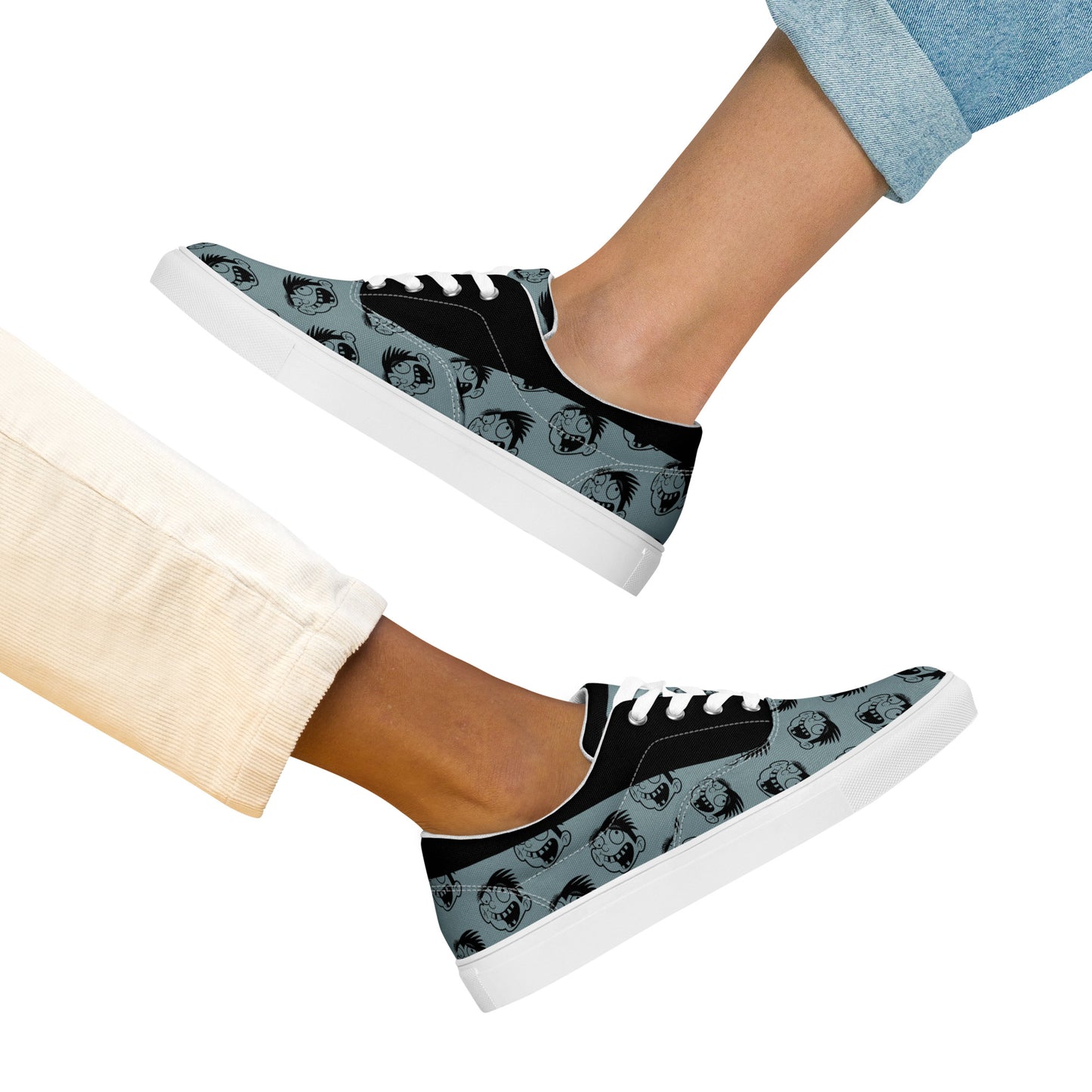 Pair of Cartoon Face Women's Lace-Up Canvas Shoes in black and gray worn by two people, showcasing casual style with low-top design and white soles.