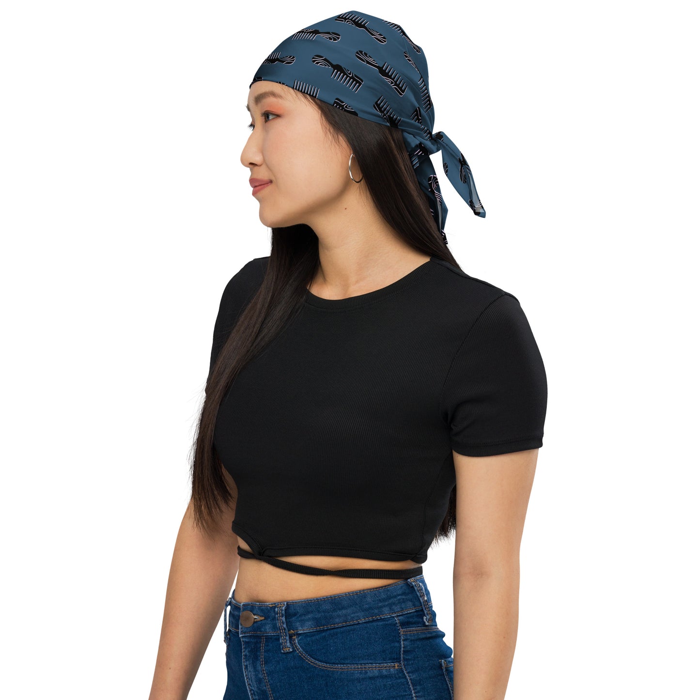 Woman wearing a blue Mini Afro Combs All-Over Print Bandana tied at the back, paired with a black cropped top and blue jeans, showcasing casual modern style.
