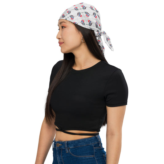 Woman wearing a white Love Is Always A Choice Bandana with a red and blue all-over print styled as a headscarf, paired with a black cropped t-shirt and blue jeans