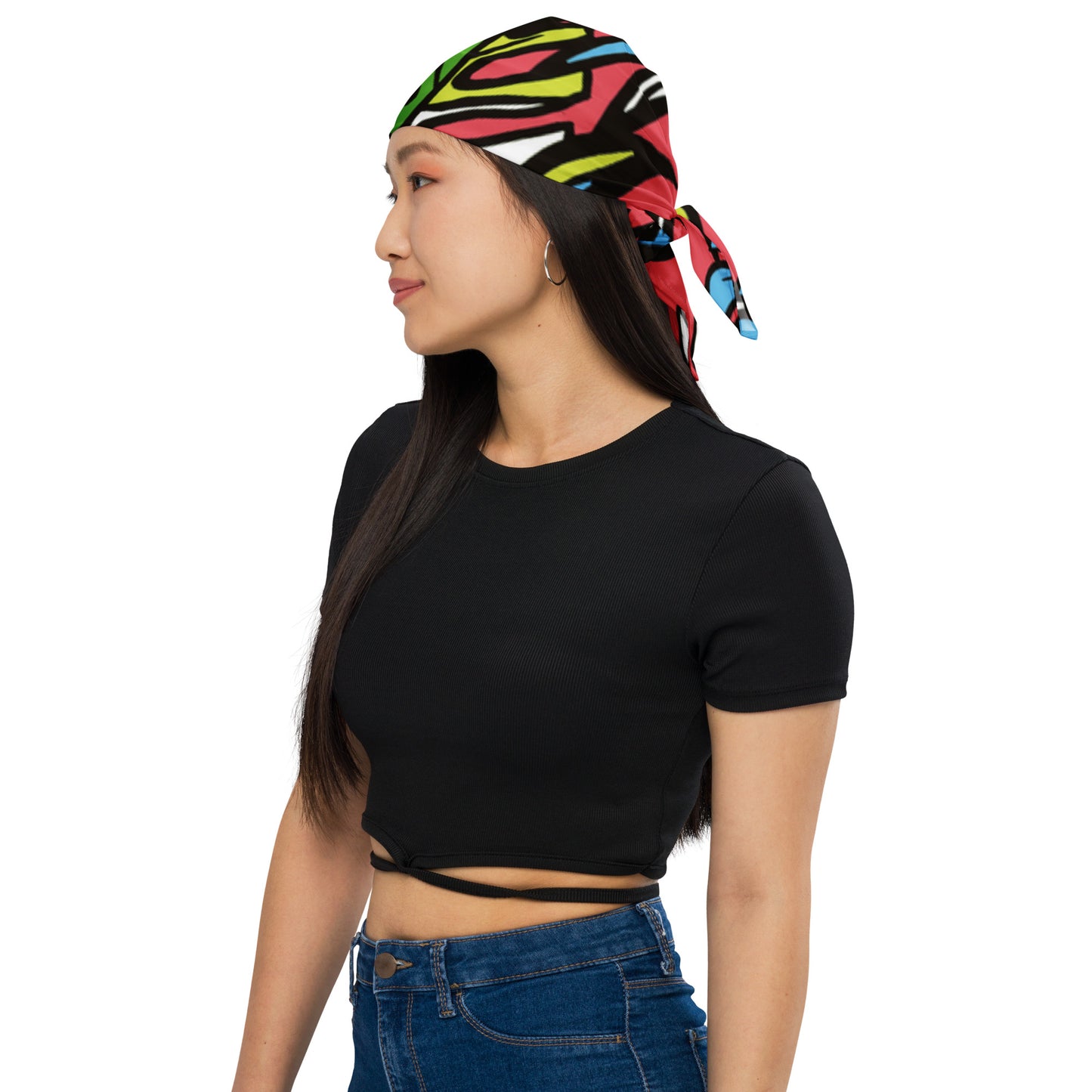 Woman wearing a colorful Tropical Palm Bandana tied around her head, paired with a black cropped top and blue jeans, showcasing casual fashion and melanin-rich style.