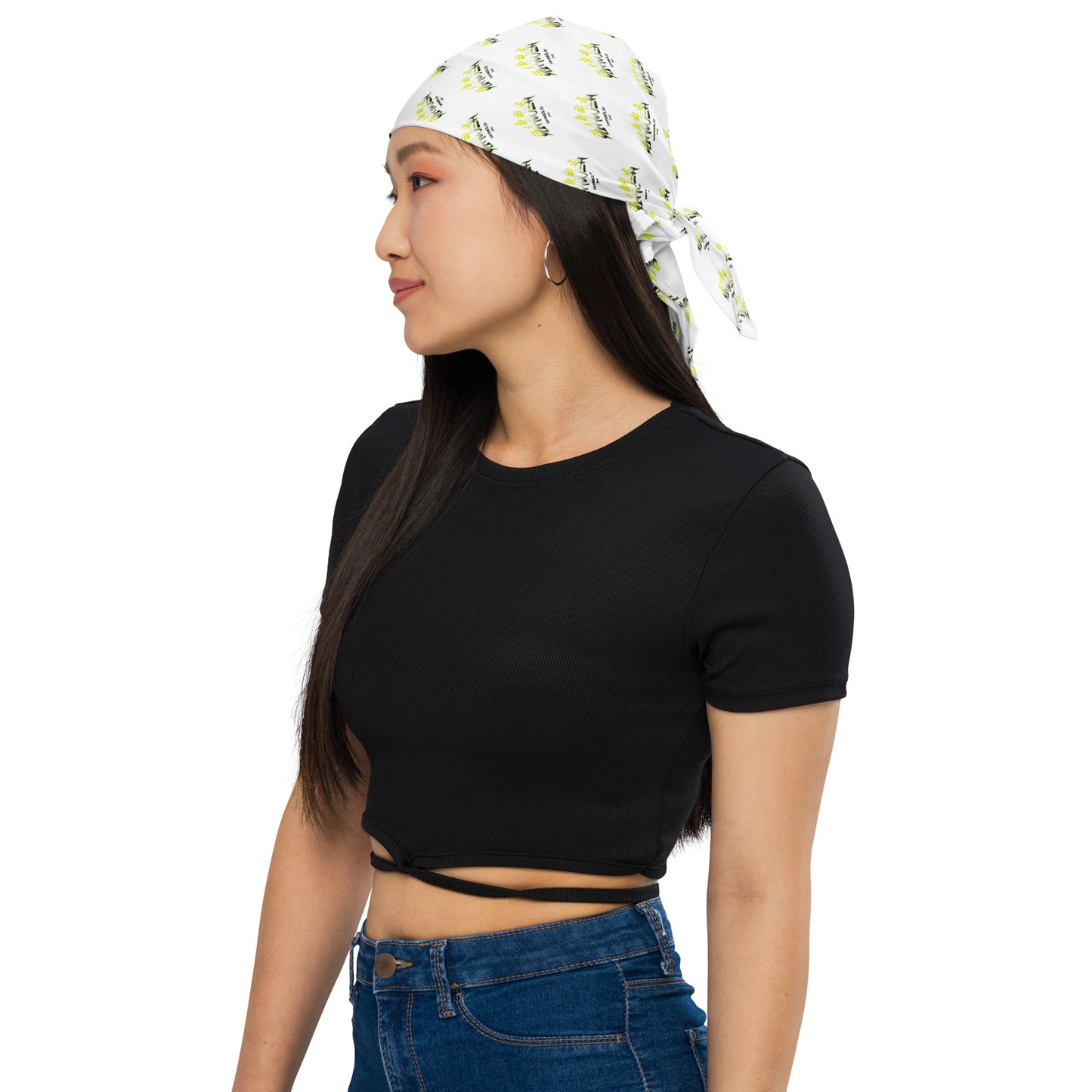 Young woman wearing a white patterned Yahweh Apparel Co. Bandana tied at the back, paired with a black crop top and blue jeans, showcasing casual faith-inspired apparel style.