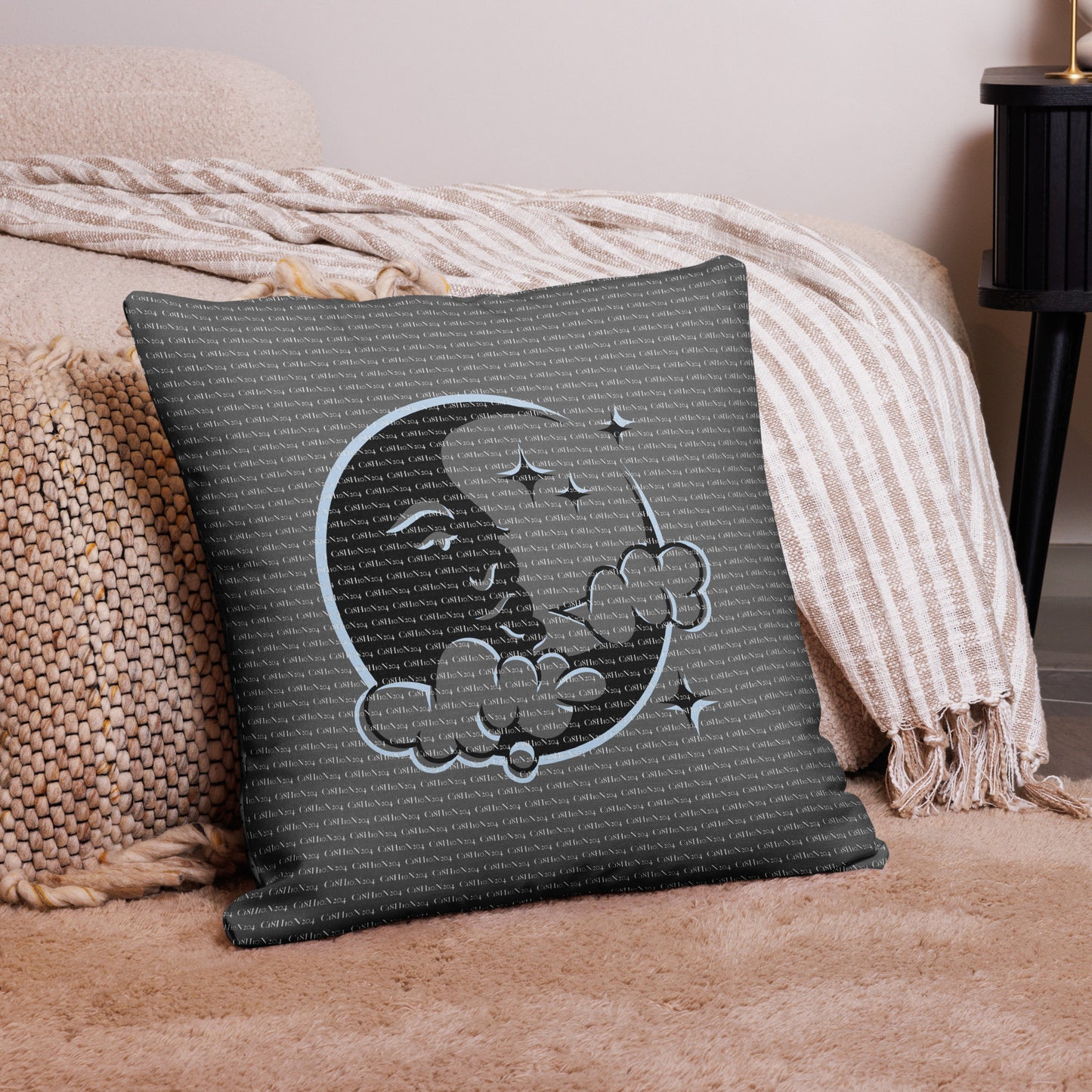 Moon Dreams Pillow featuring a serene crescent moon with a peaceful face surrounded by clouds and stars, set against a dark textured background for cozy home decor.