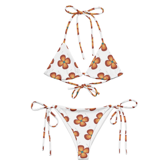 Flower Power Orange & Brown Recycled String Bikini with a white base and retro-style orange and brown flower print, featuring adjustable tie straps on the top and bottom.