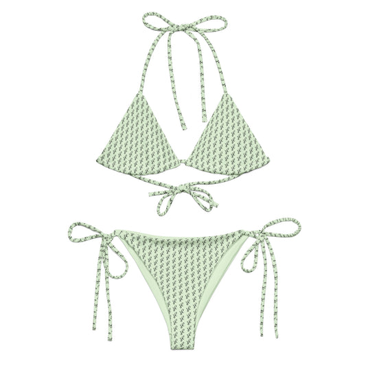 Emerald Script Recycled String Bikini in light green with delicate dark script pattern, featuring adjustable tie straps on top and bottom for a customizable fit.