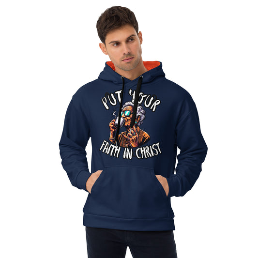 A man wearing a navy blue Put Your Faith in Christ Hoodie featuring a colorful graphic of a person with sunglasses and gray hair holding a cross, with hands in the front pocket.