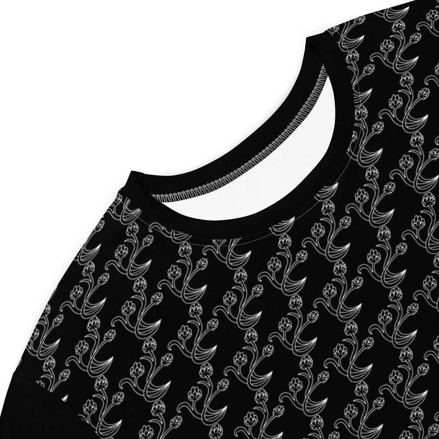 Close-up of the neckline and upper section of the Black & Gray Chain Loop T-Shirt Dress featuring a black fabric with a repeating delicate gray floral chain pattern.