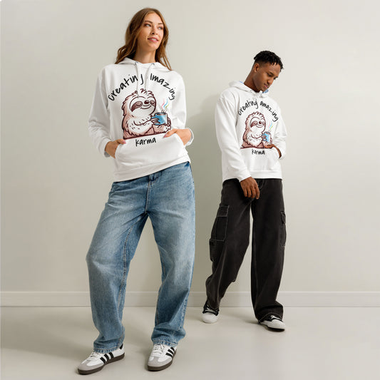Two models wearing white Hoodie – Let Karma Handle It featuring a relaxed sloth graphic and phrase "Creating Amazing Karma," styled with casual jeans and cargo pants in a minimalist setting inspiring purpose-driven faith apparel.