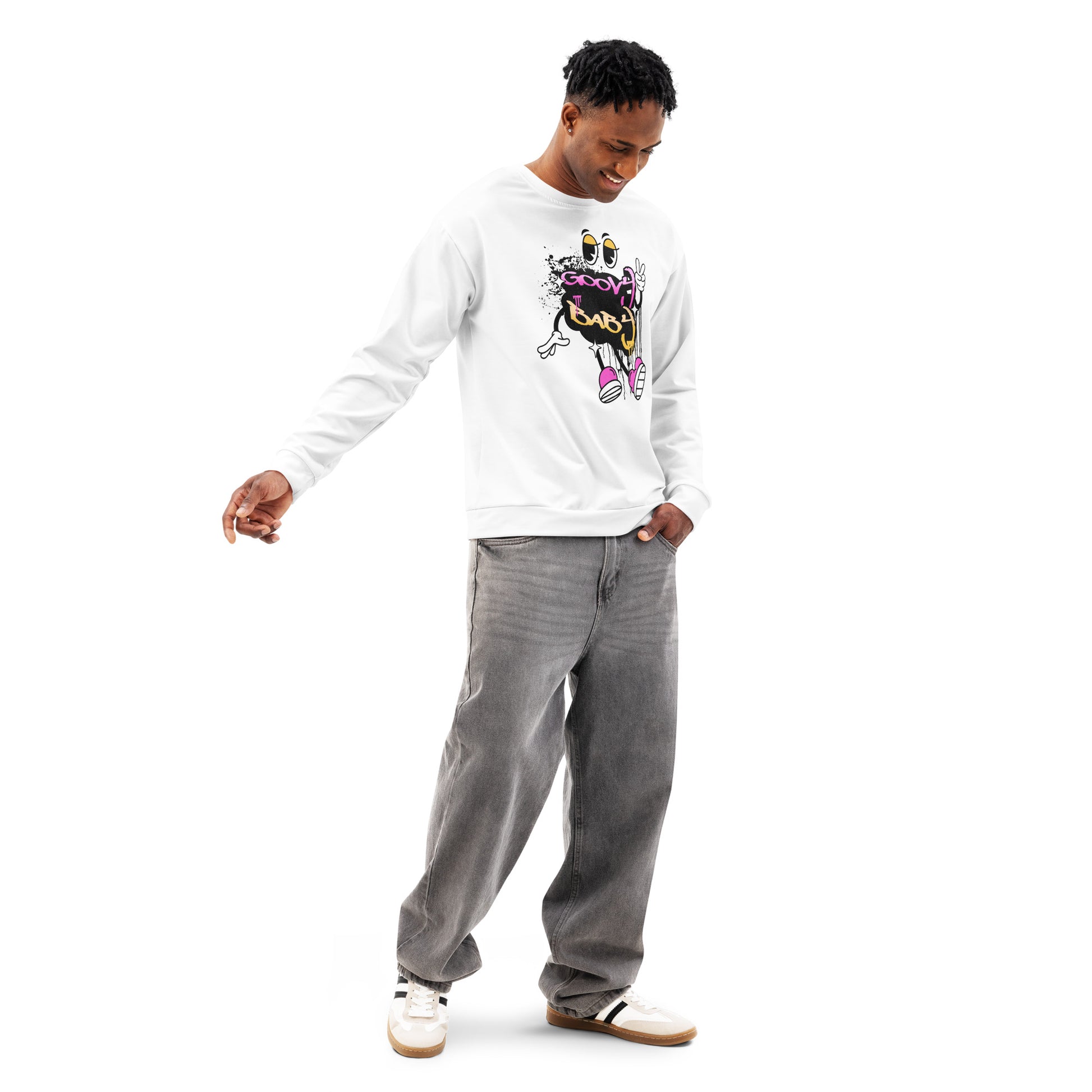 Man wearing a white cotton Groovy Baby Sweatshirt with a colorful, playful graphic design, paired with grey jeans and white sneakers, standing against a white background.