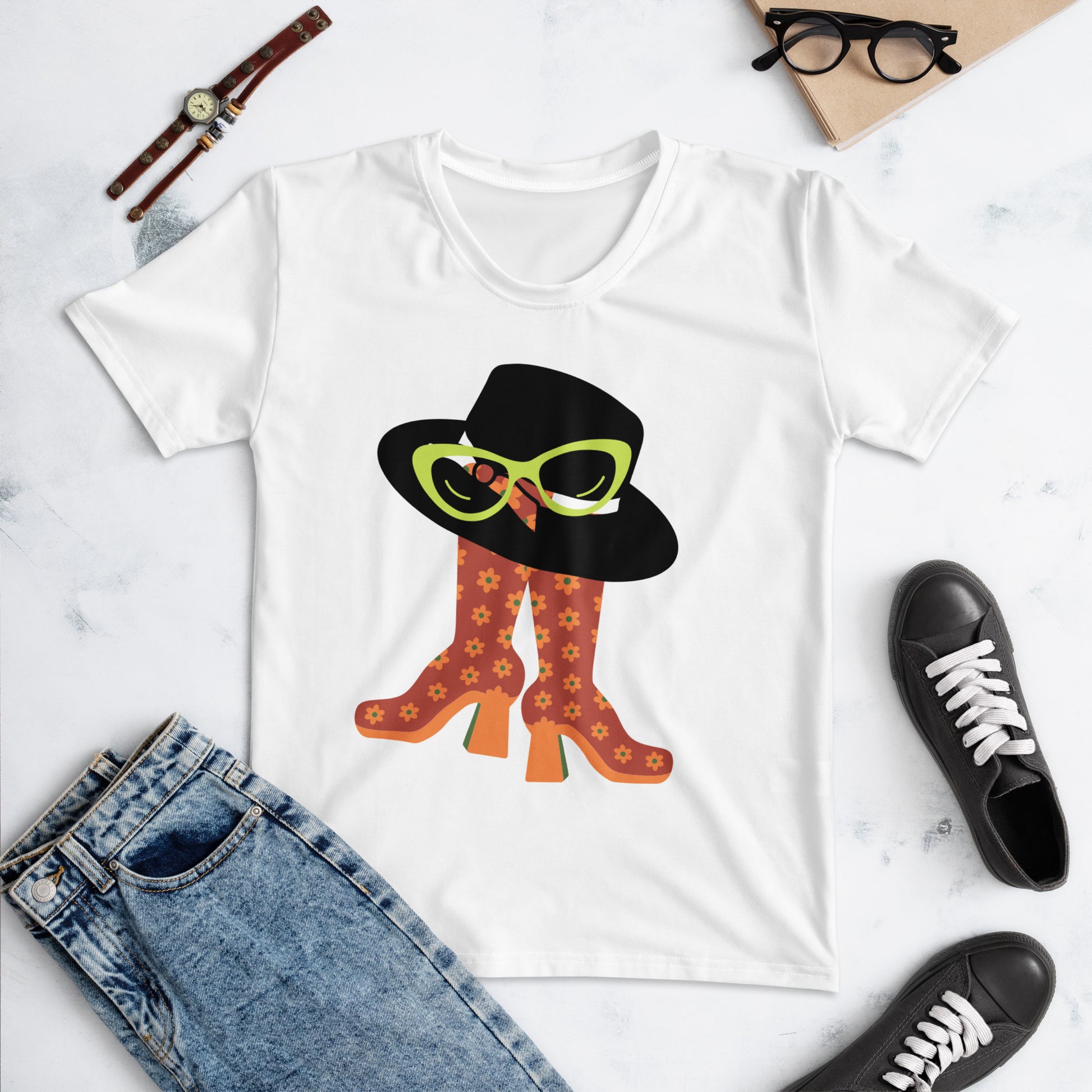 White Glam Squad Women's T-Shirt featuring a graphic of orange floral patterned boots, a black wide-brim hat, and lime green cat-eye sunglasses, styled with casual accessories.