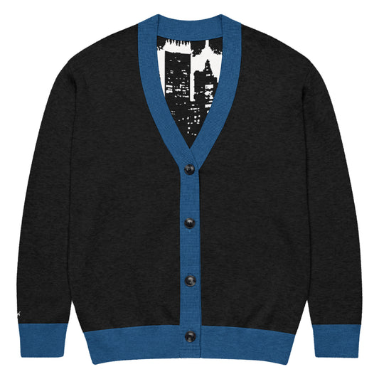 Knitted Cardigan – Street Art featuring a black knit design with blue trim and buttons, showcasing urban-inspired artwork inside, combining melanin-rich imagery and purpose-driven messaging.