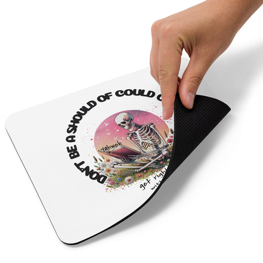 Hand holding up a white Should've Would've Could've Mouse Pad featuring a colorful skeleton design with floral accents and inspirational text on a non-slip black base.