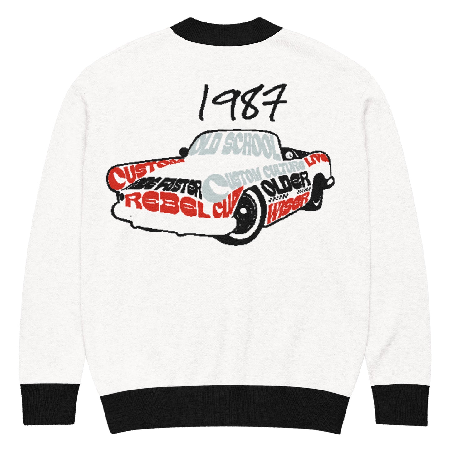 White knitted cardigan with black cuffs and collar featuring a 1987 vintage car design made of bold text, showcasing the Knitted Cardigan – 1987 Rebel from faith-inspired apparel with purpose-driven messaging.