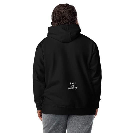 Person wearing a black Coffee Distressed Teddy Unisex Hoodie shown from the back with a small "Items Less Mentioned" logo near the bottom, paired with gray pants.