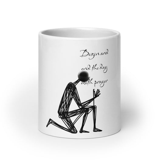 Mug – Prayer Warrior featuring a white glossy ceramic design with a black wireframe figure kneeling in prayer and the phrase "Begin and end the day with prayer," reflecting faith-inspired apparel and gifts with purpose-driven messaging.