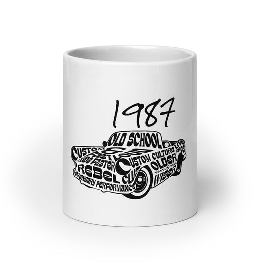 White glossy mug featuring a black graphic of a car with words like "Old School" and "Rebel Club" under the year 1987, titled Mug – Vintage '87 Cruiser, faith-inspired with purpose-driven messaging.