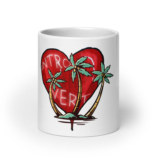 White glossy mug – My Kind of Island featuring a red heart with the word introvert and three palm trees, blending faith-inspired design with melanin-rich imagery and purpose-driven messaging.